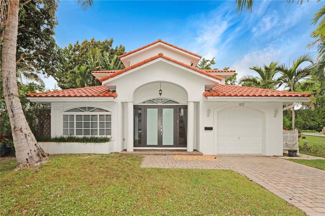 Set in one of the most desirable locations, this beautiful two story residence is surrounded by lush tropical landscaping and blends classic charm with modern comfort.