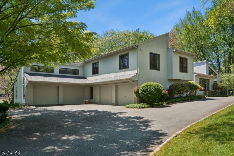 Set on a beautifully landscaped lot just minutes from downtown Morristown, this striking contemporary home offers the open, airy floor plan today's buyers want, lots of windows, soaring ceilings, warm ...