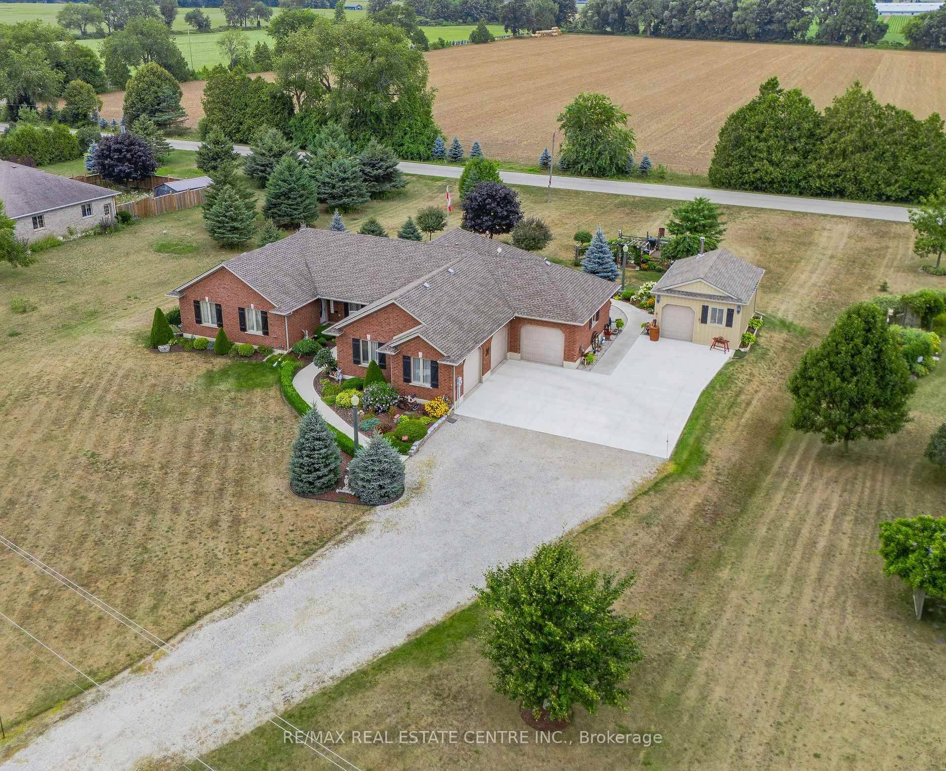 This all brick bungalow sits on just under an acre of beautifully landscaped land, featuring a 3 car attached garage and a fully insulated workshop with hydro, wood stove, and ...