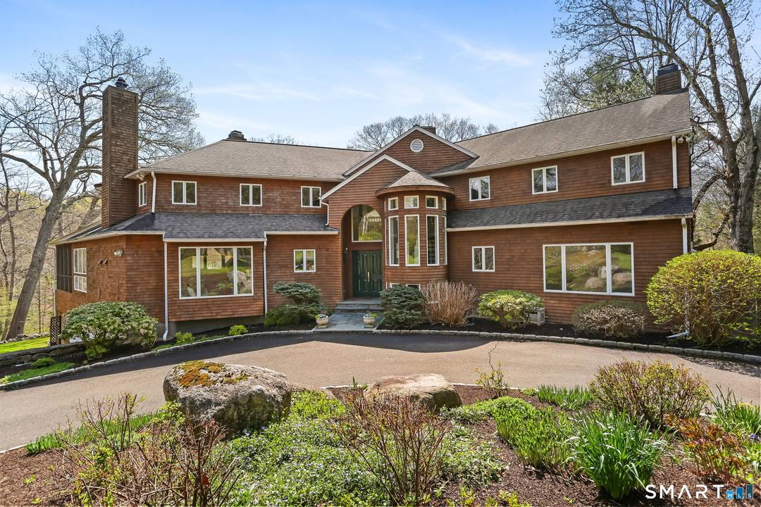 A four season retreat where open lawns, a beautiful pool, and the surrounding landscape create a sense of quiet luxury.