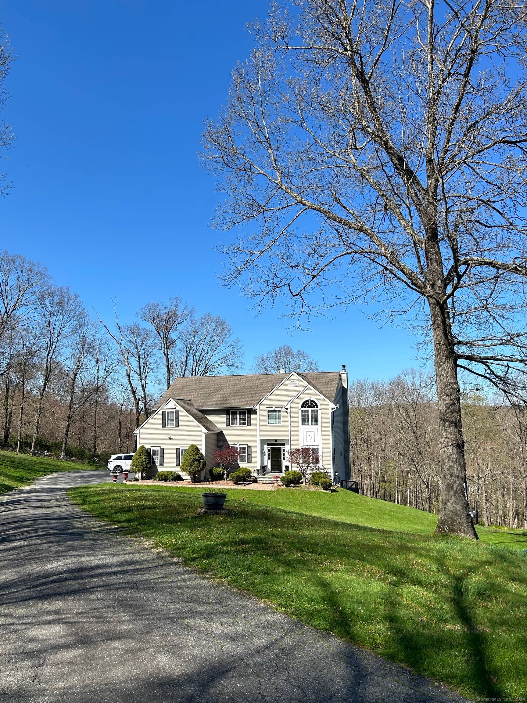 Perfectly located, Spacious colonial in an enclave of 3 homes tucked back off Brookfield's most picturesque country road.