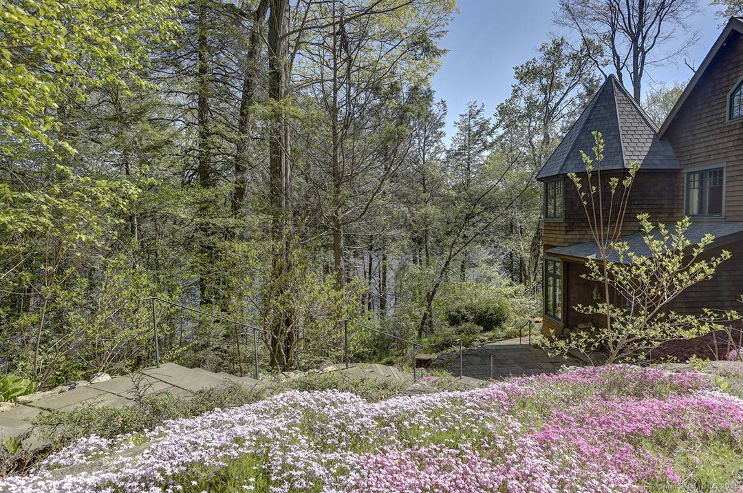 Tower Hill house sits on 7 acres with 800 feet of frontage along the western shore of Doolittle Lake in Norfolk, CT.