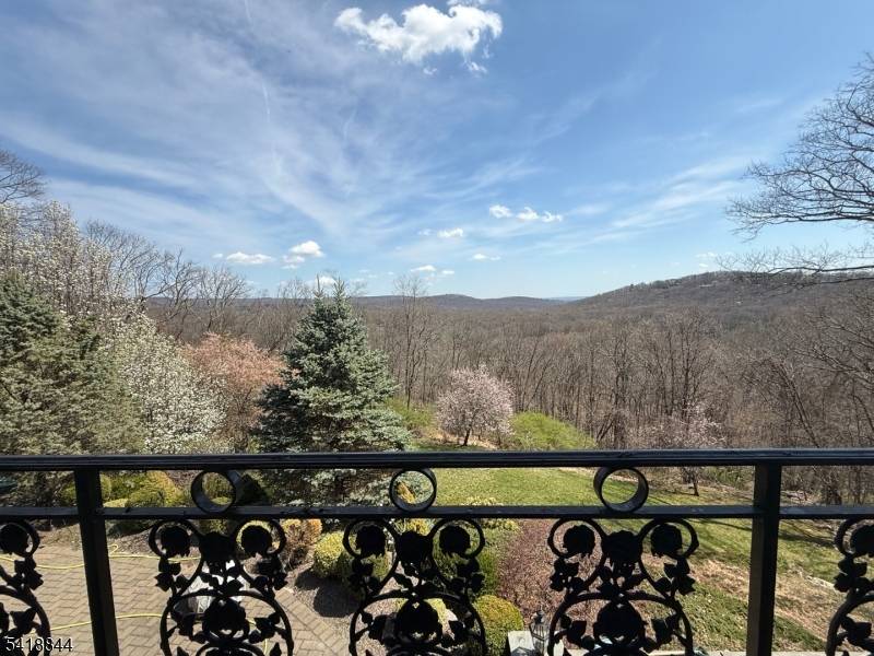 Unsurpassed elegance and panoramic mountain views describe this unique custom built and meticulously renovated home set back on 1.