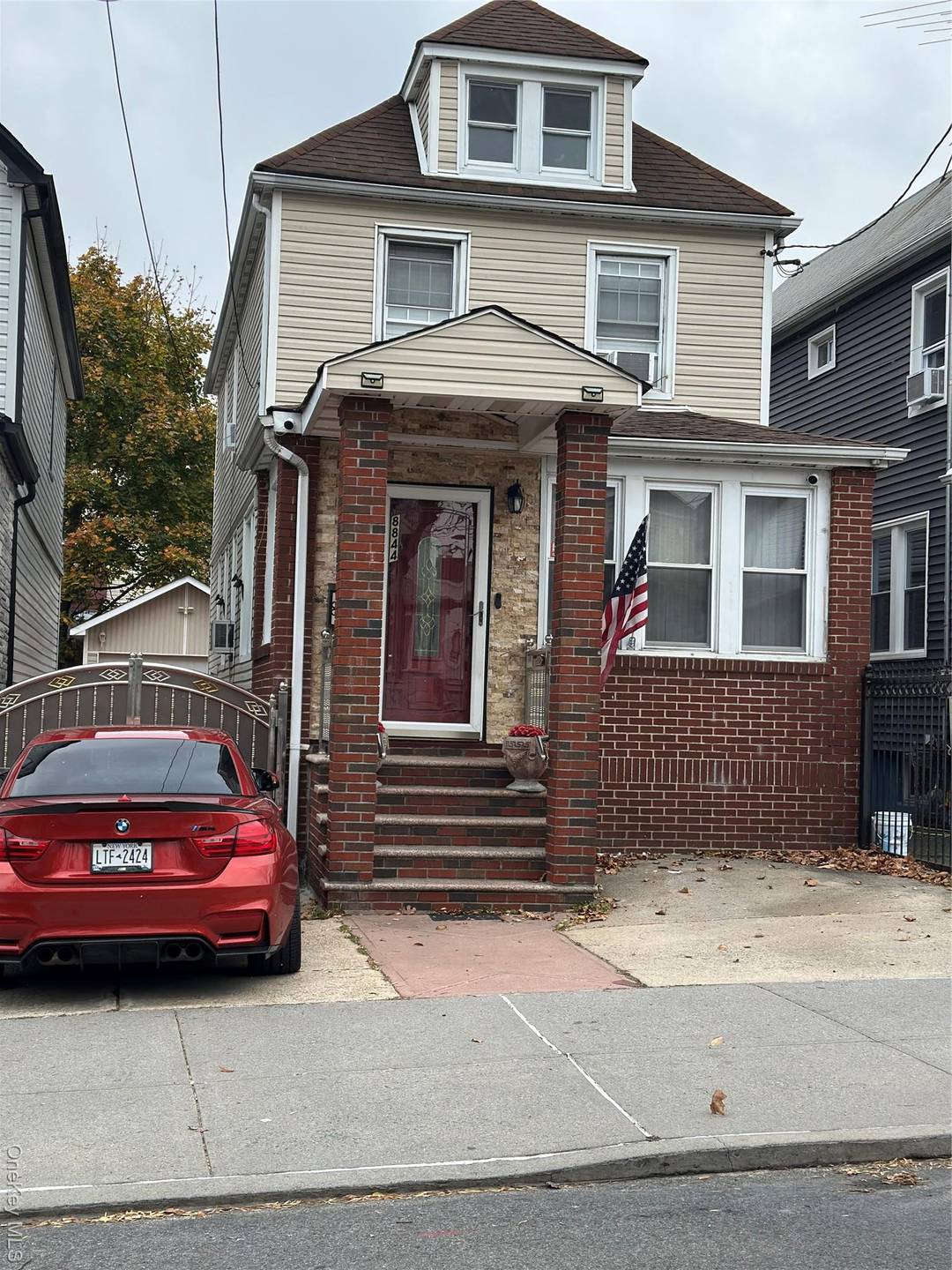 Updated single family with private driveway, garage, finished attic, and full finished basement with separate entrance in prime Hollis location.