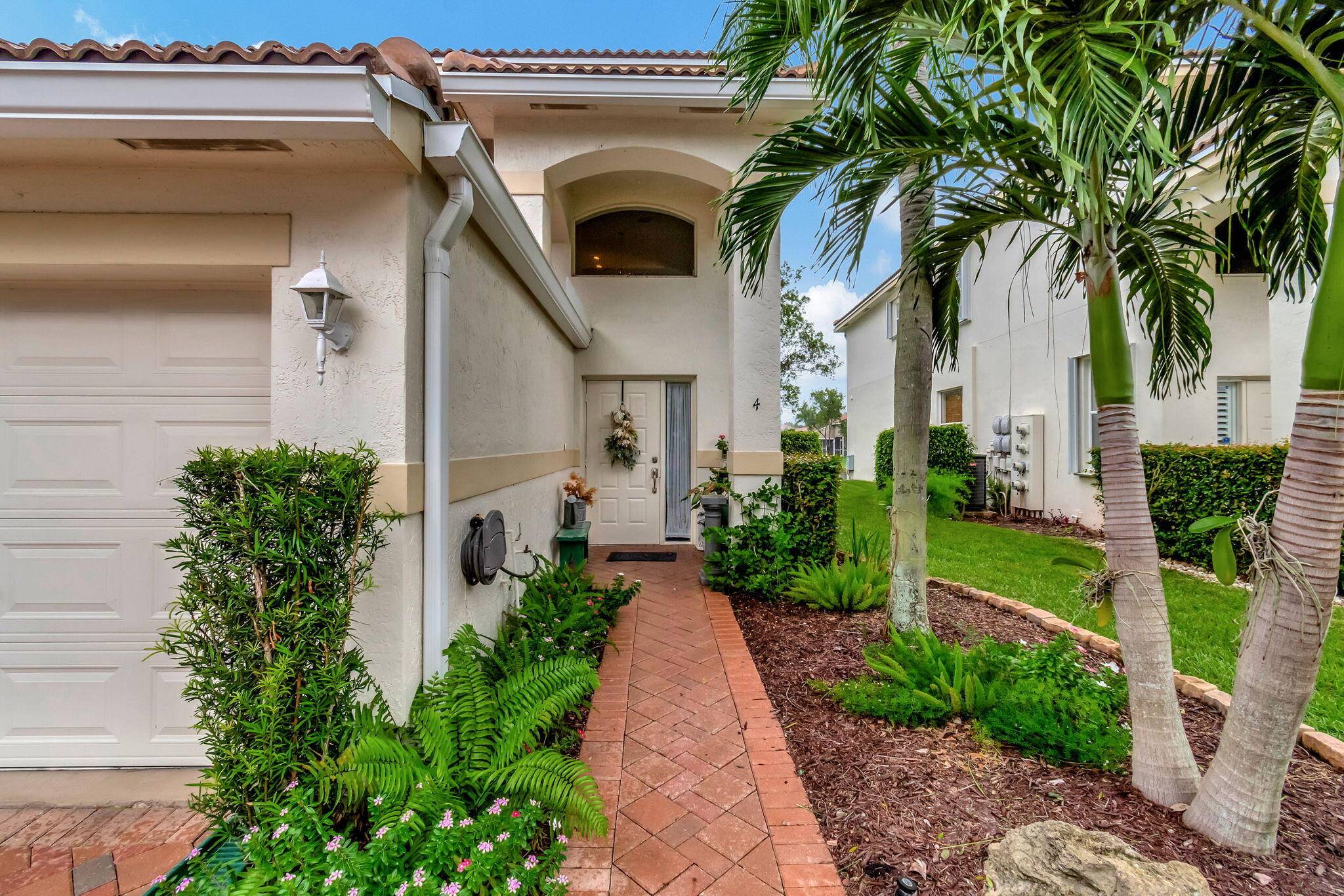 Beautifully updated lakefront coach home in The Grove at Boynton Beach.