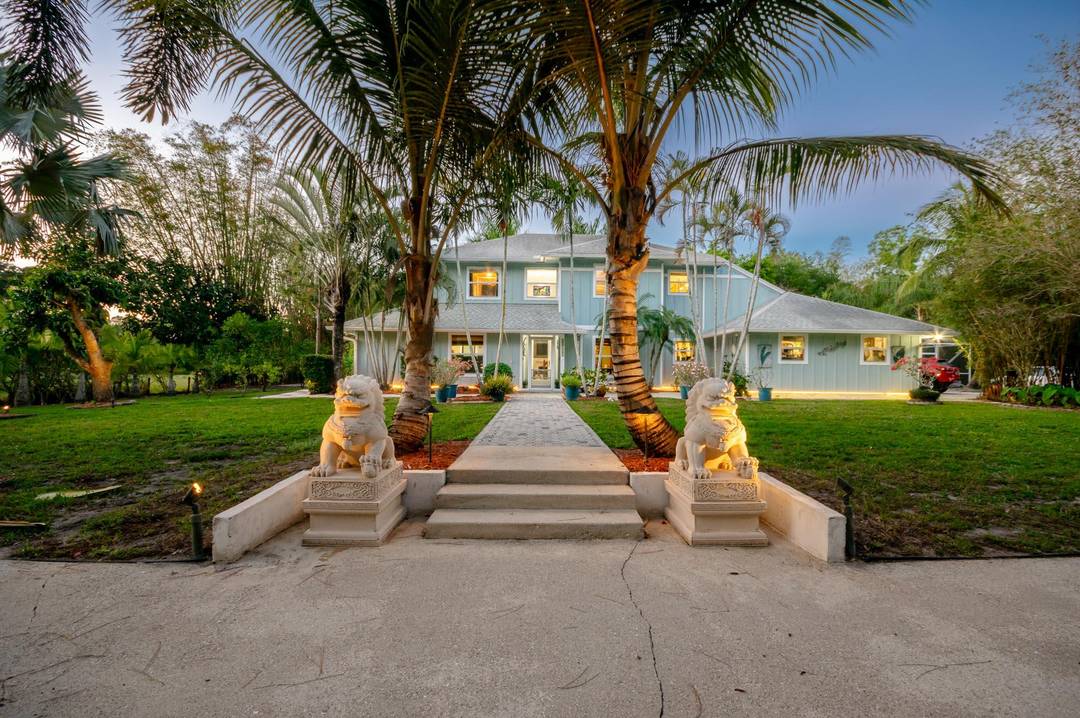 Stunning private retreat in Jupiter Farms this one of a kind estate is nestled on over an acre of serene land and boasts 4 bedrooms, 3.