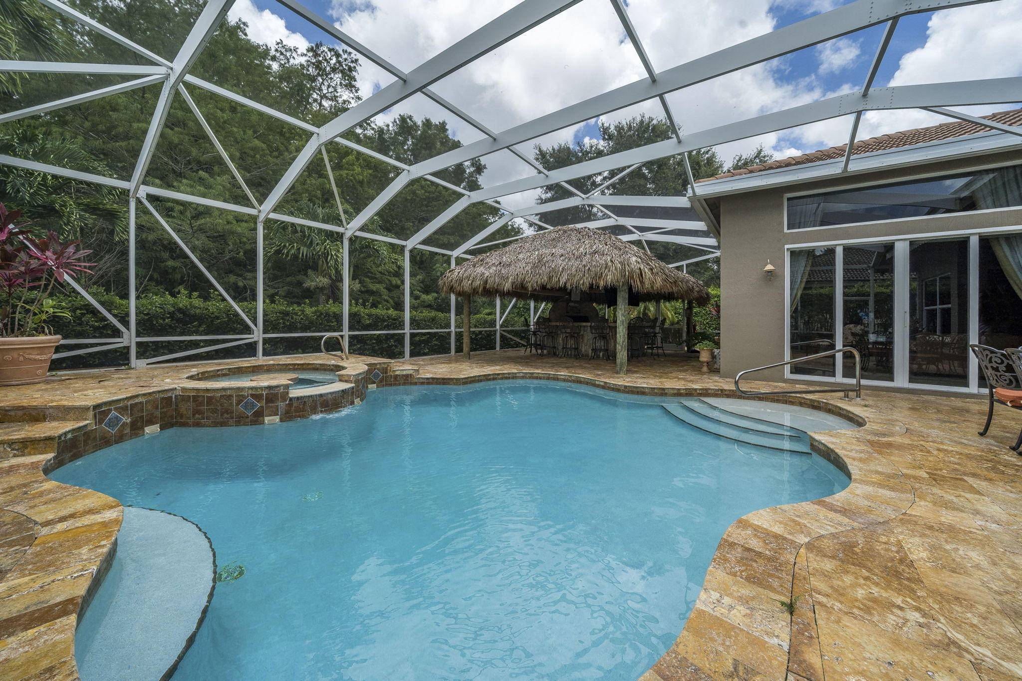 This is the perfect house for entertaining with the screened heated pool Spa area and under the stunning TiKi bar with a built in Alfresco grill and 60 inch TV.