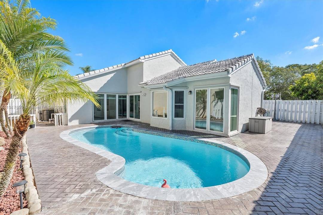 This gorgeous 3 bed, 2 bath pool home sits in a peaceful gated community with a very low HOA.