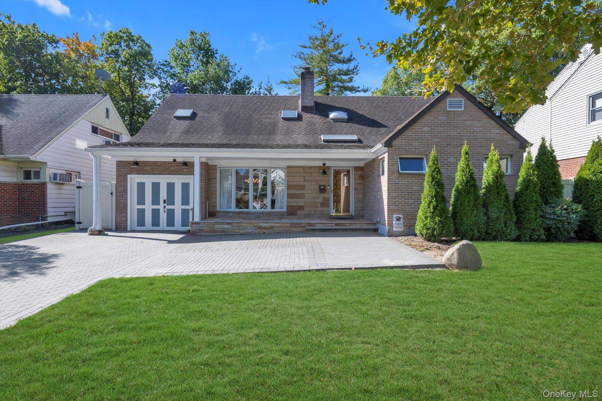 Expanded Cape situated on a beautiful tree lined block with thoughtful landscaping, paver double driveway, front yard, and backyard entertaining space.