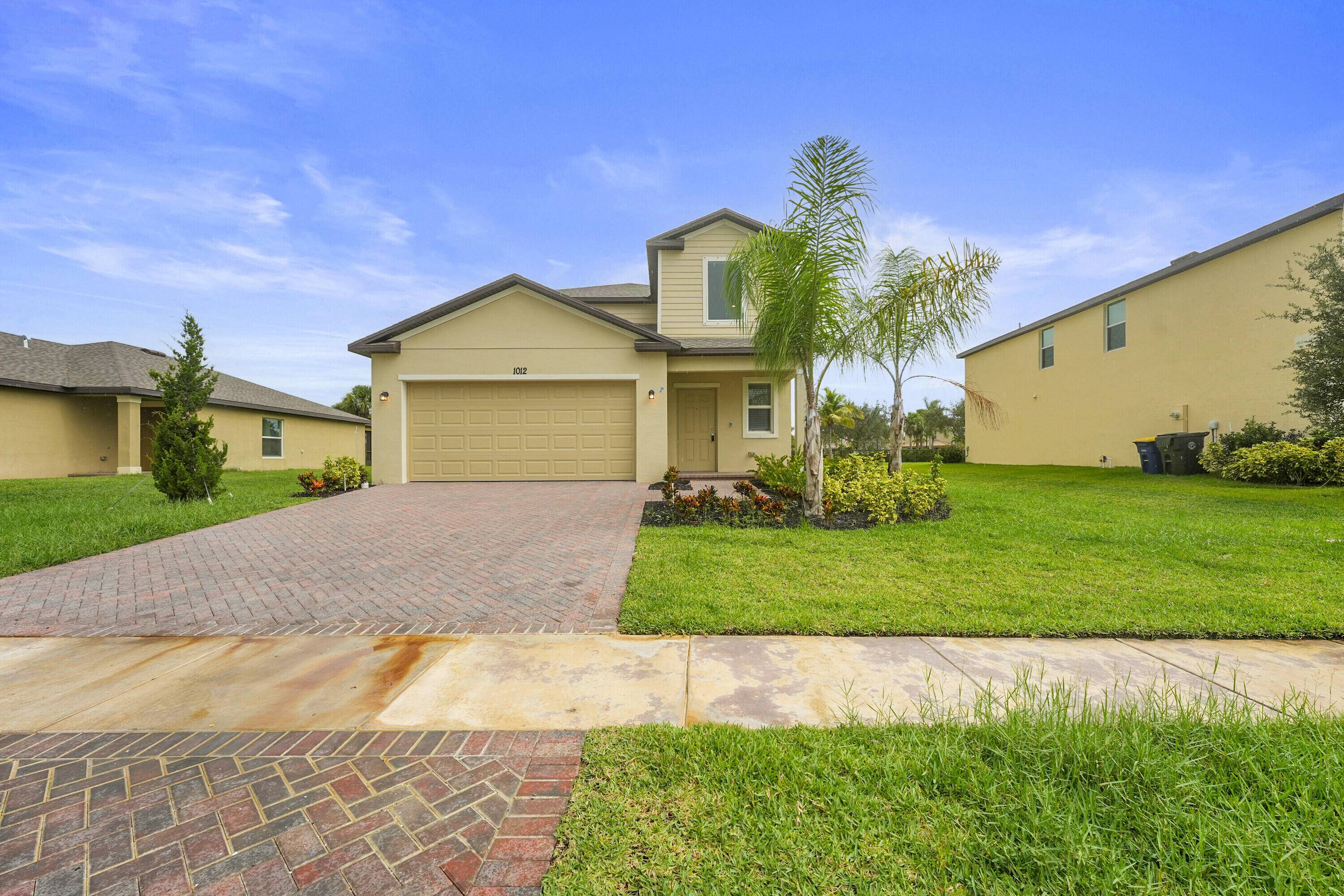 Two story home with an open layout, seamlessly integrating a first floor kitchen with a central island, a dining room and a welcoming family room with patio access.