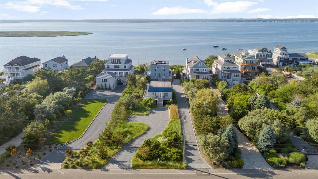 Experience the essence of relaxed coastal living, elevated by timeless design and exceptional rarity, at this unparalleled bayfront compound on Dune Road.