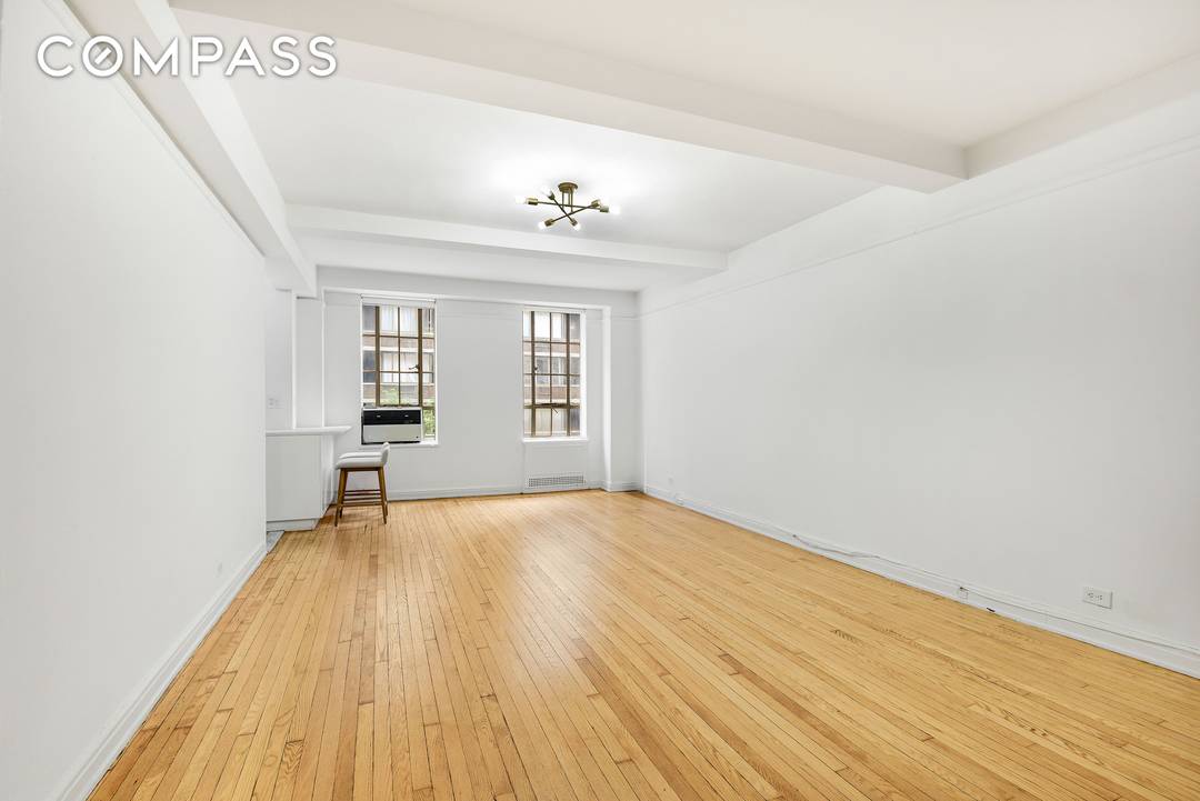Step into serene treetop views and timeless charm in this oversized prewar alcove studio at the coveted Parc Vendome condominium.