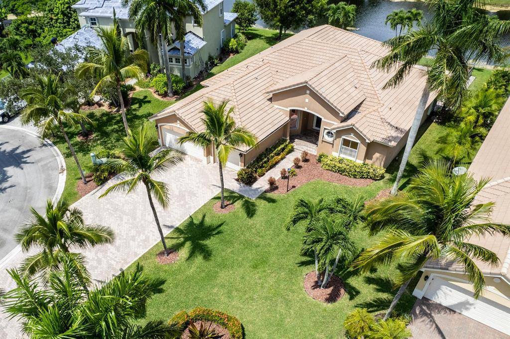 Set in the prestigious estate section of Parkland Isles, this stunning home offers impressive curb appeal and magnificent water views.