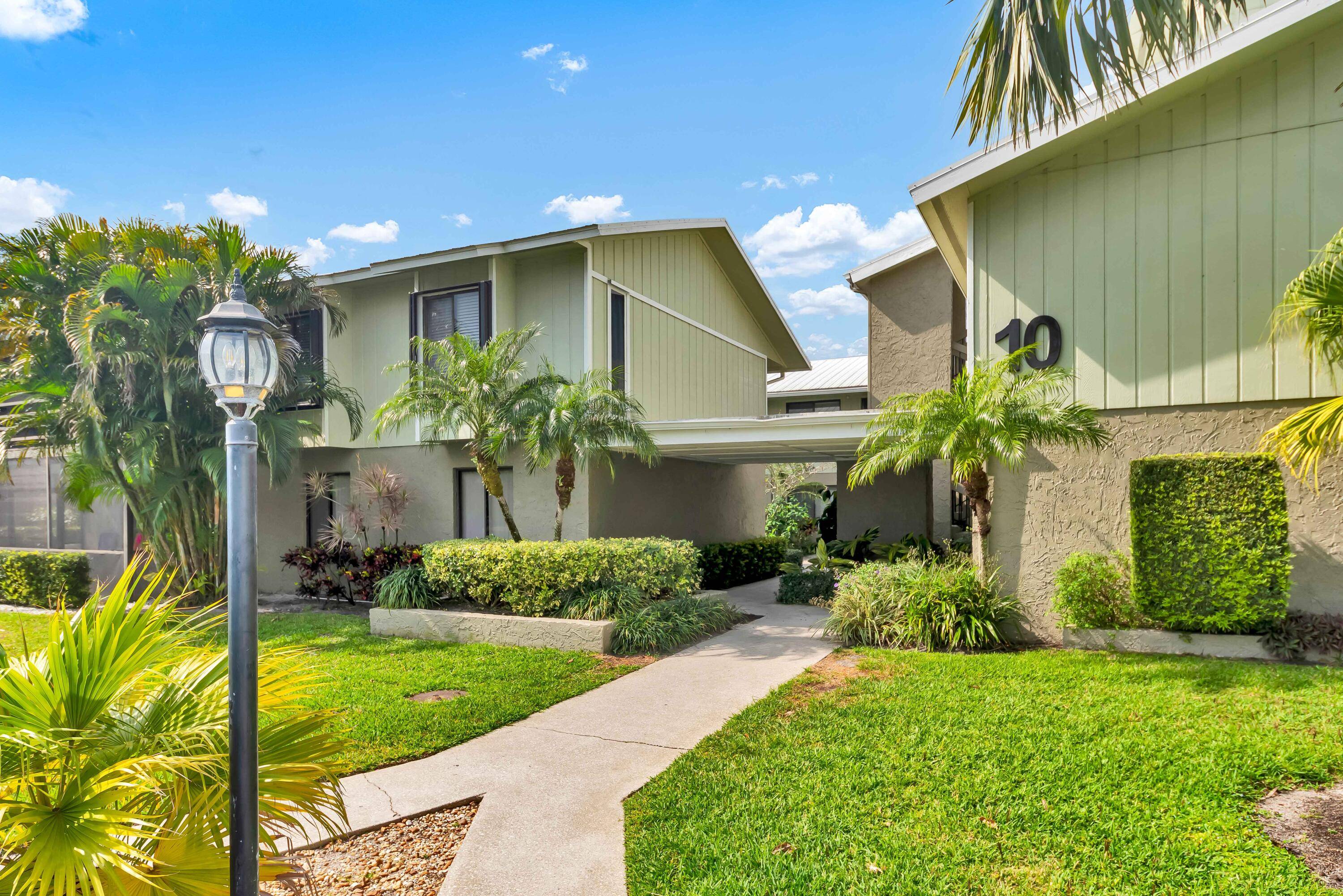 Live minutes from Downtown Stuart in this bright private second floor corner unit with an open, tiled living space featuring IMPACT windows and vaulted ceilings.
