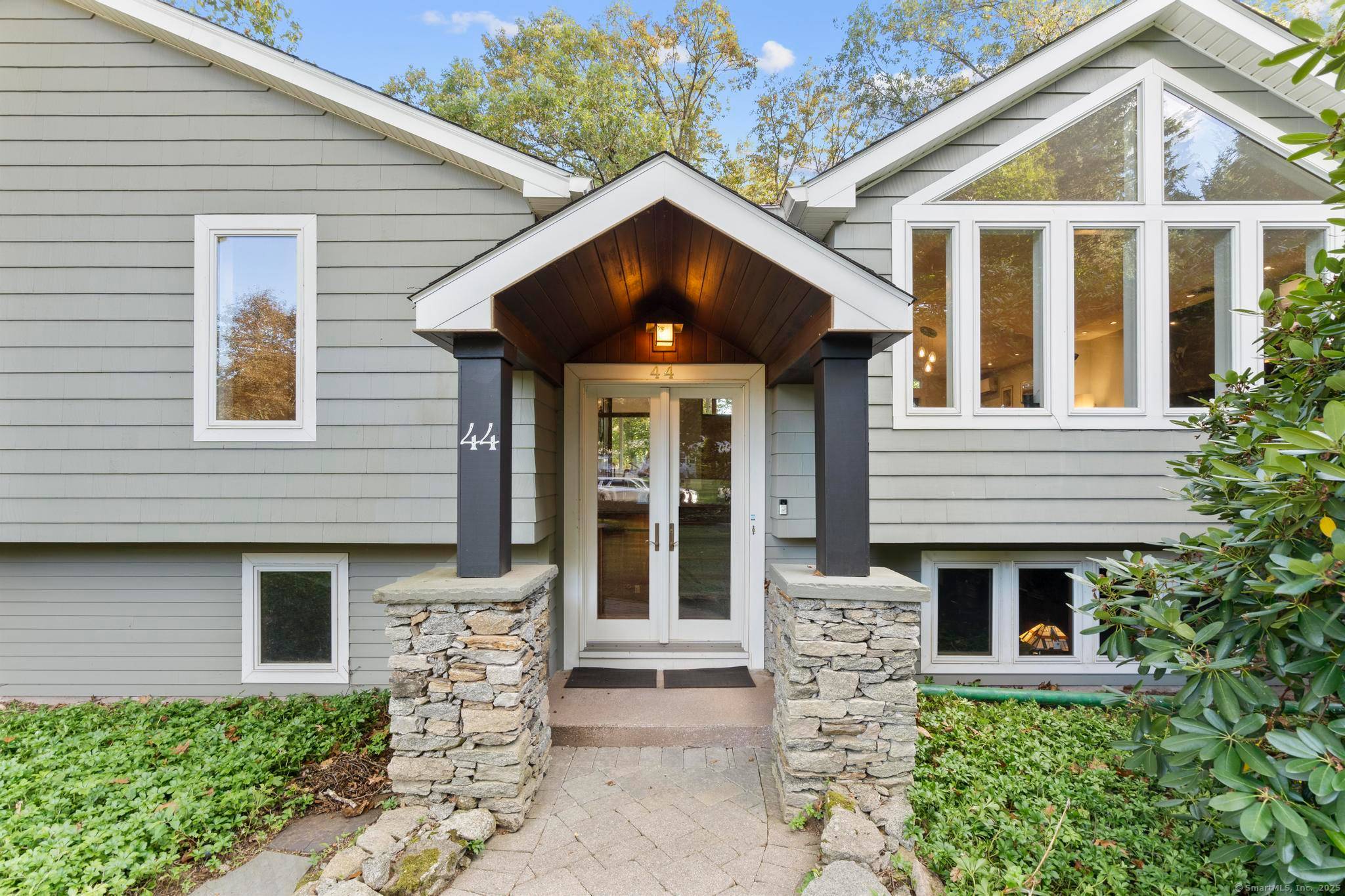 Welcome to your own retreat a lovingly renovated raised ranch on a lush, artfully landscaped lot.