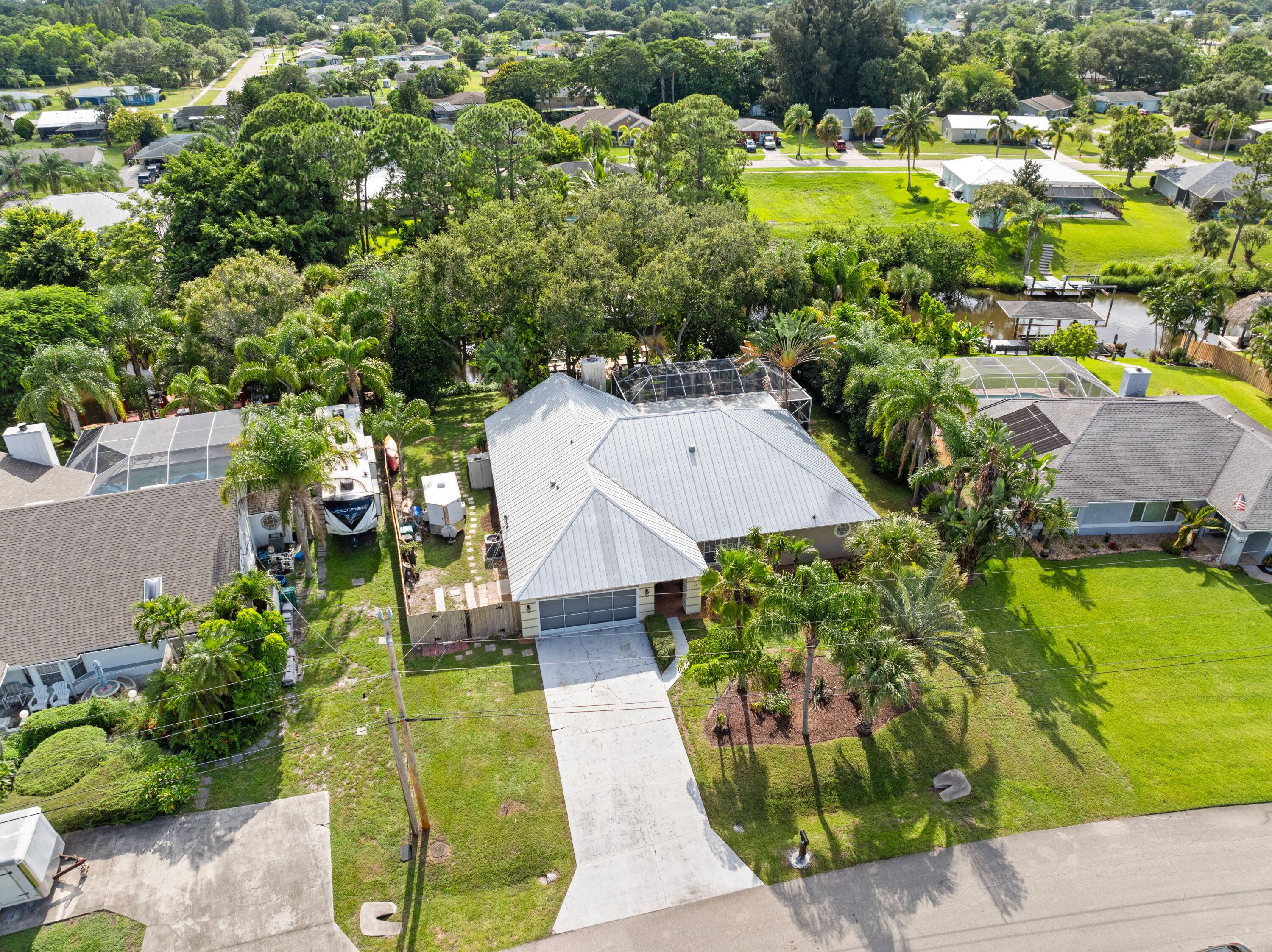Enjoy serene water views from the screened patio, heated pool and hot tub ideal for relaxing evenings or outdoor dining.