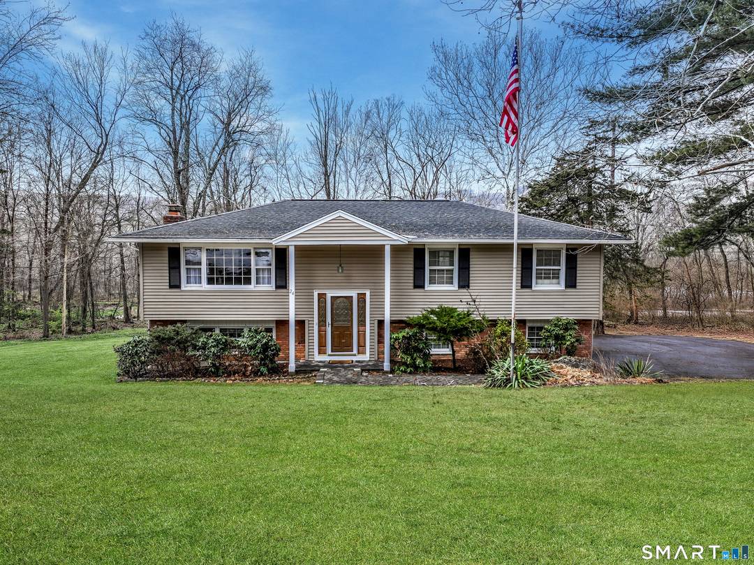 One of a kind raised ranch featuring front and back staircases !