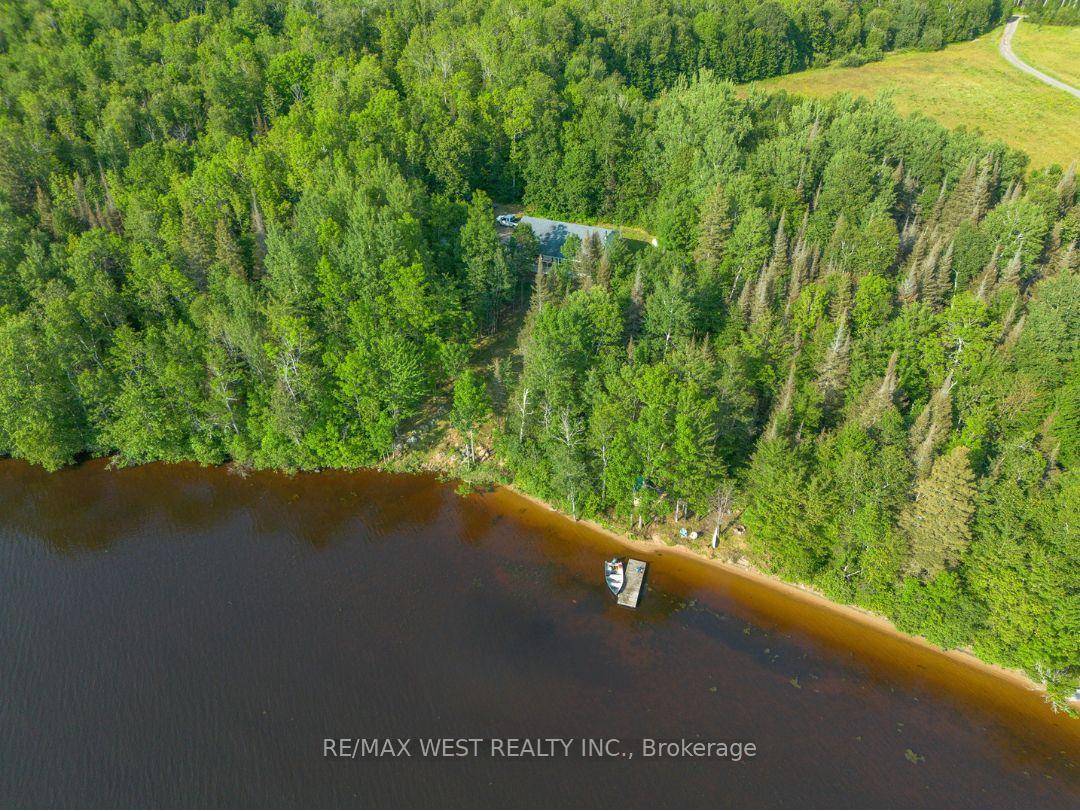 Discover serenity at 501 Golf Course Road on the shores of Wasi Lake !