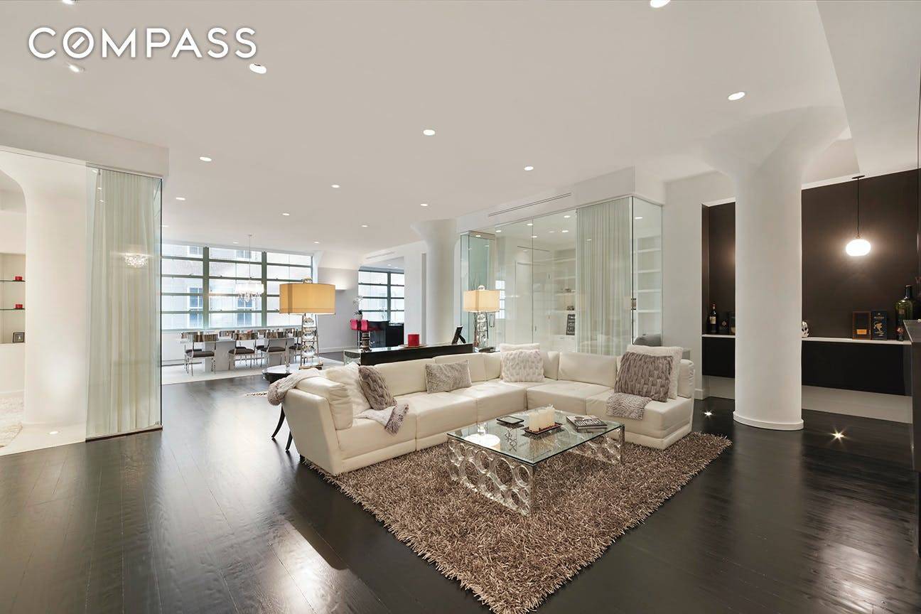 This meticulously renovated loft has 2 bathrooms with 3 bedrooms and features 11 foot ceilings, beautiful oak floors, a decorative fireplace, custom drapes, over sized windows with automatic shades, central ...