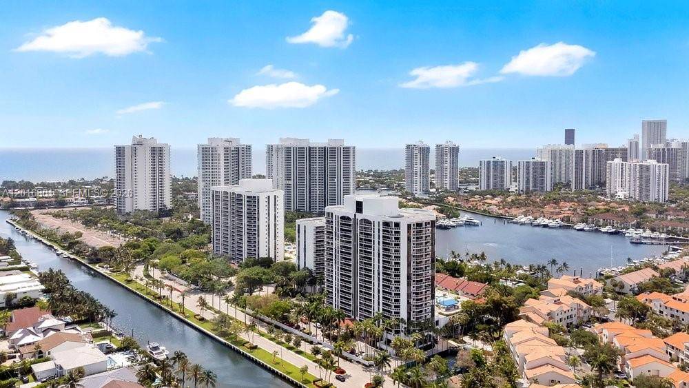 Stunningly updated 2 bed, 2 bath residence with den at the Yacht Club Aventura, featuring spectacular waterway and canal, ocean, and skyline views.
