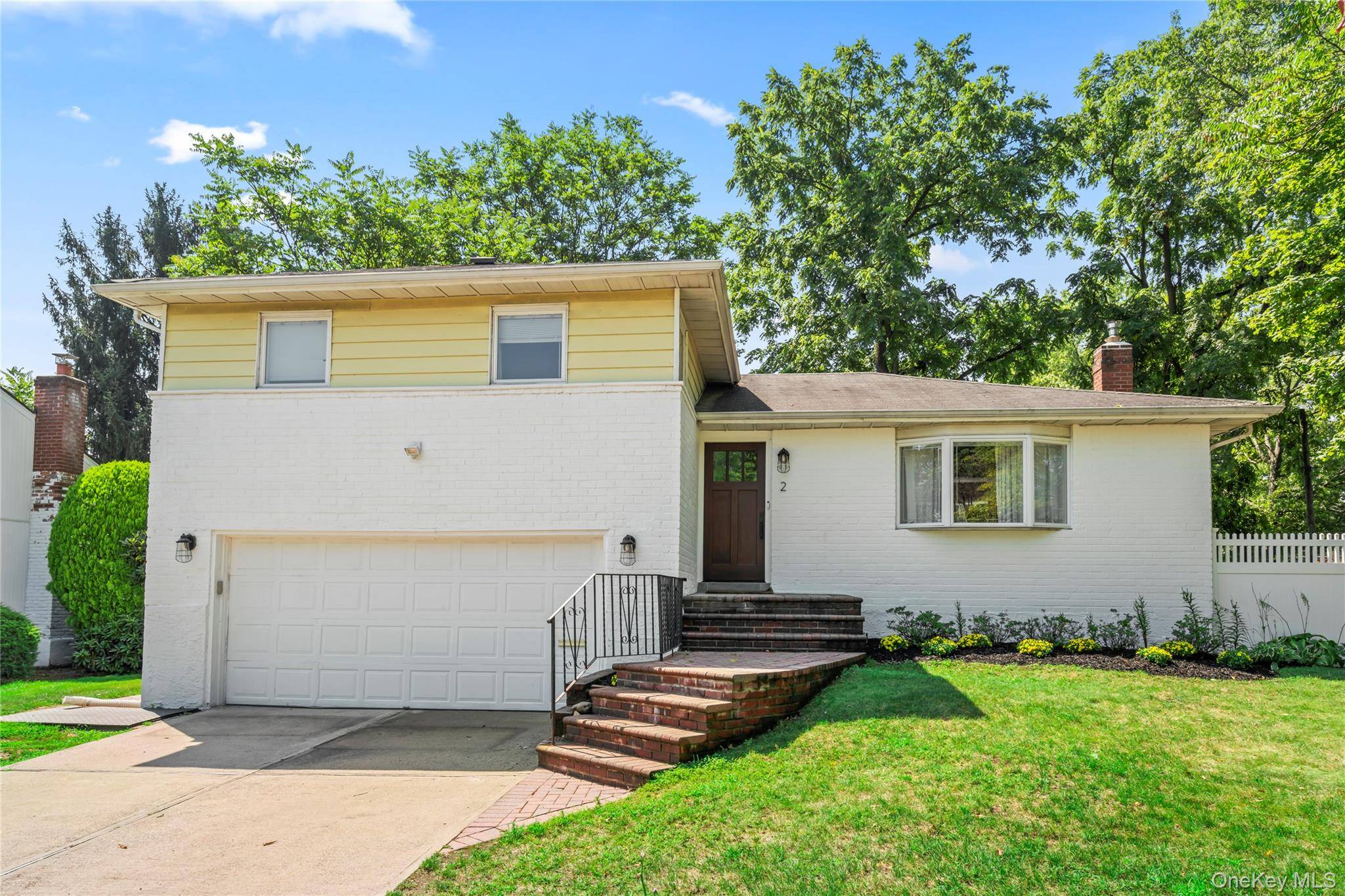 SEARINGTOWN Nestled on an oversized, tree lined corner lot in the heart of Searingtown, this beautifully updated brick and siding split level home offers style, space, and comfort.