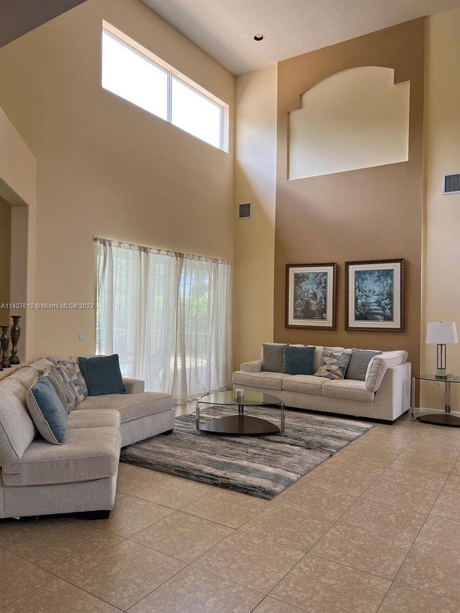 2 Story Pool Home, Located in a quite neighborhood of Wellington Shores this stately Mediterranean style include a towering ceiling, open floor plan.