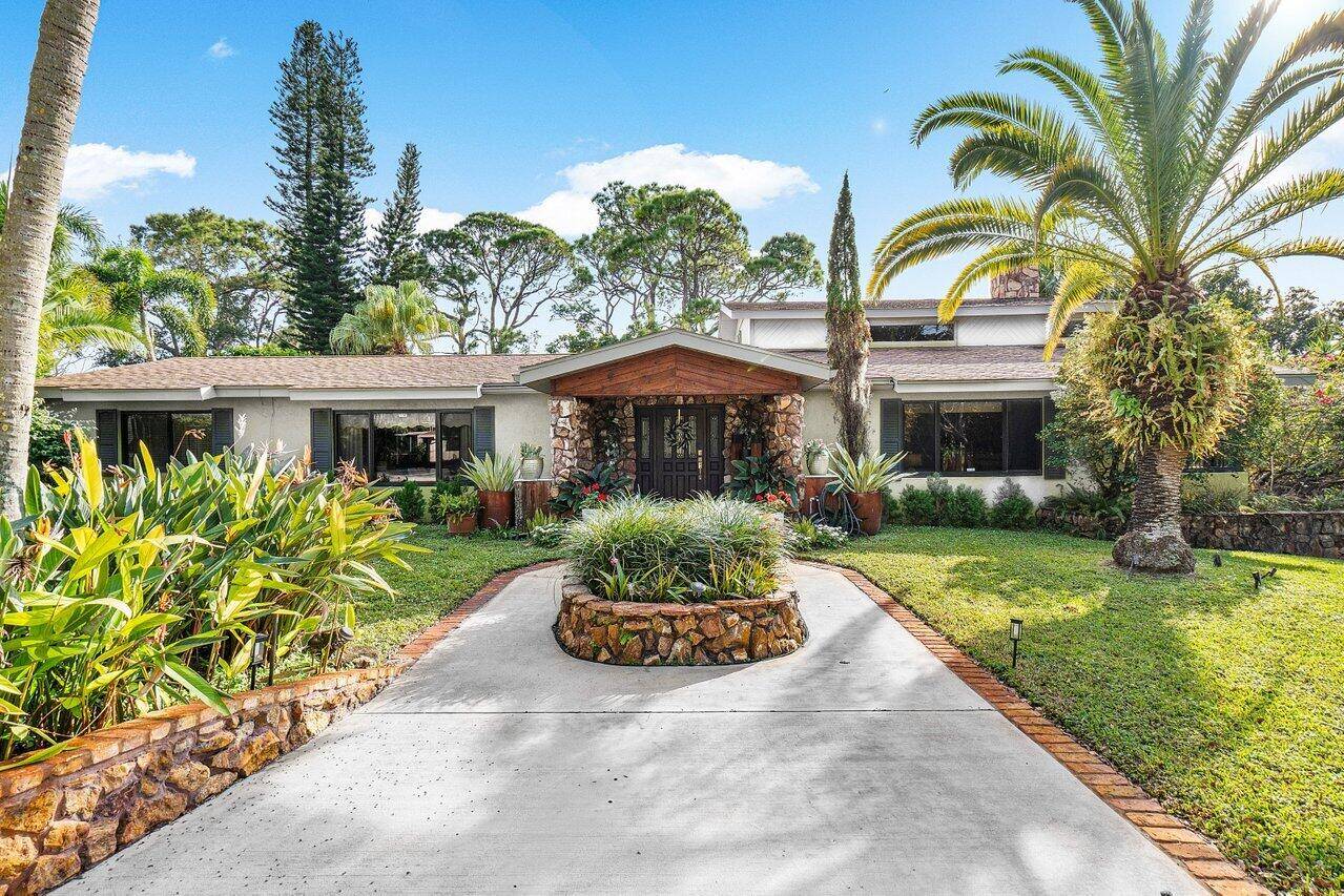 Discover Southern charm and modern elegance on over an acre of lush, private grounds along Boynton Beach's coveted High Ridge Road.
