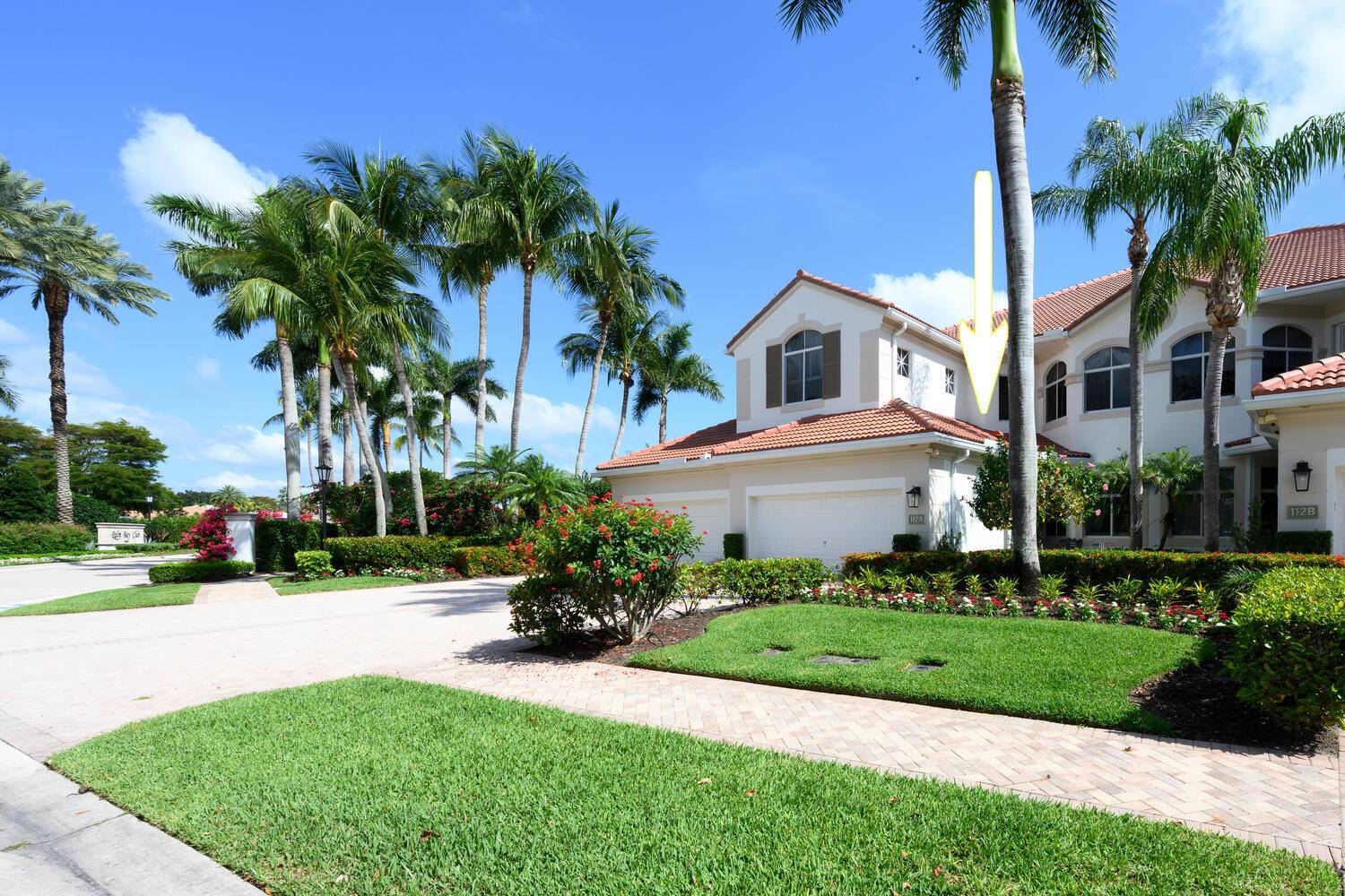 Experience the ultimate in luxury and privacy with this beautifully maintained 1st floor end unit in the exclusive Palm Bay Club at BallenIsles Country Club.