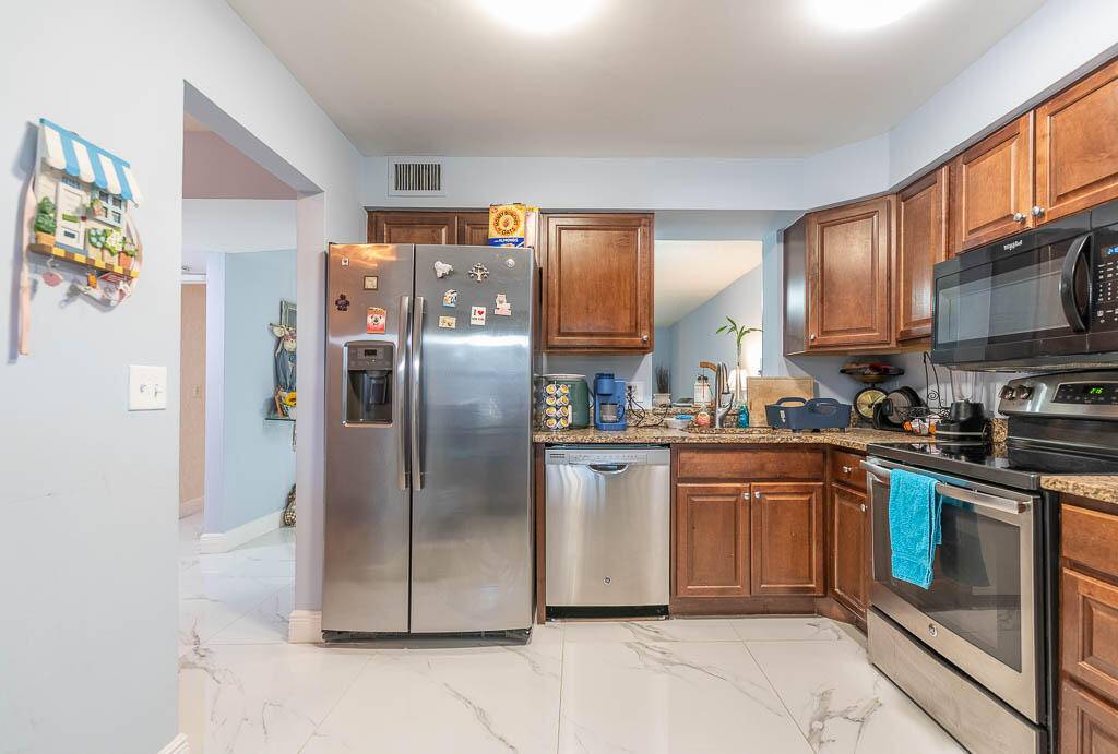 Amazing 2 bed 2 bath lake view corner unit with IMPACT DOORS AND WINDOWS in 55 community.