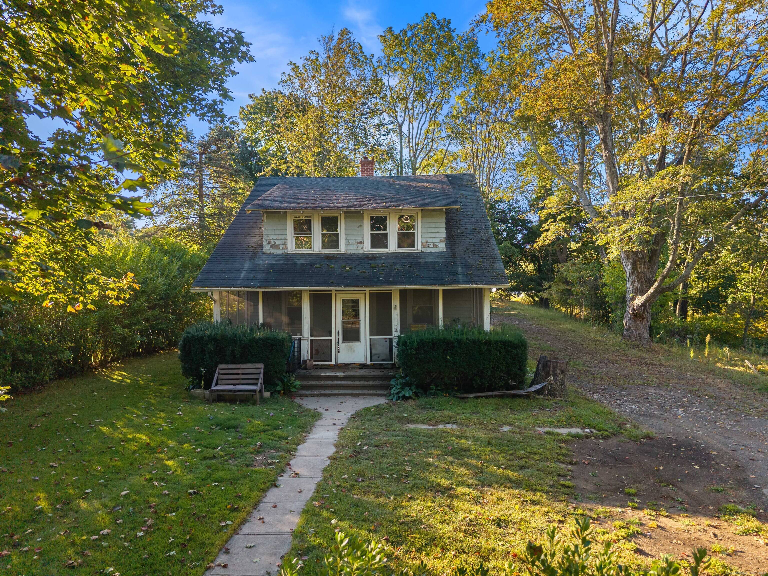 Nestled on just under an acre in town, this classic 1930's bungalow offers a rare opportunity to own a piece of Madison's history with endless potential.