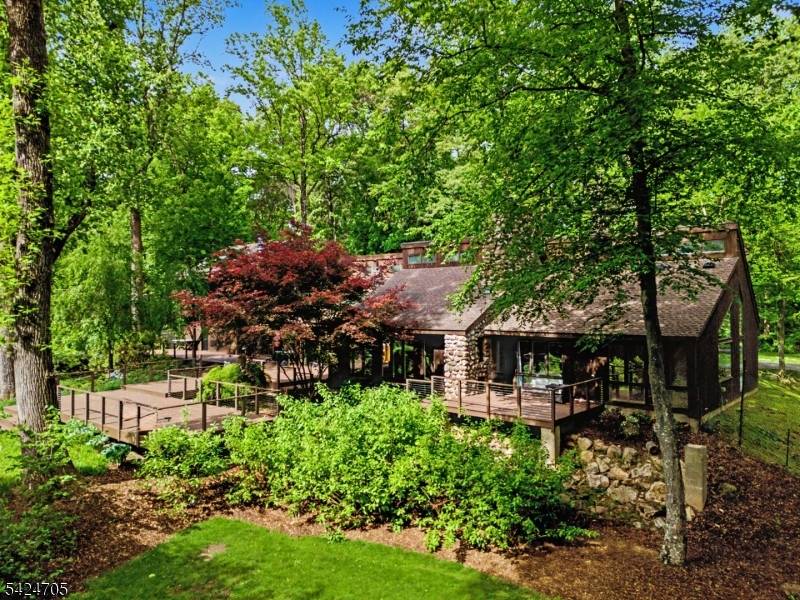This curated contemporary blends refined modern style with the feel of a year round vacation home, nestled on 5 ultra private wooded acres just minutes from town.