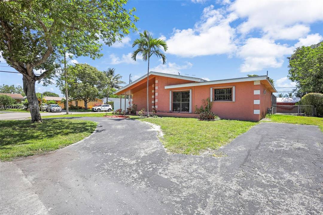 Oversized corner pool home with circular driveway and extra side space for a boat or additional parking.