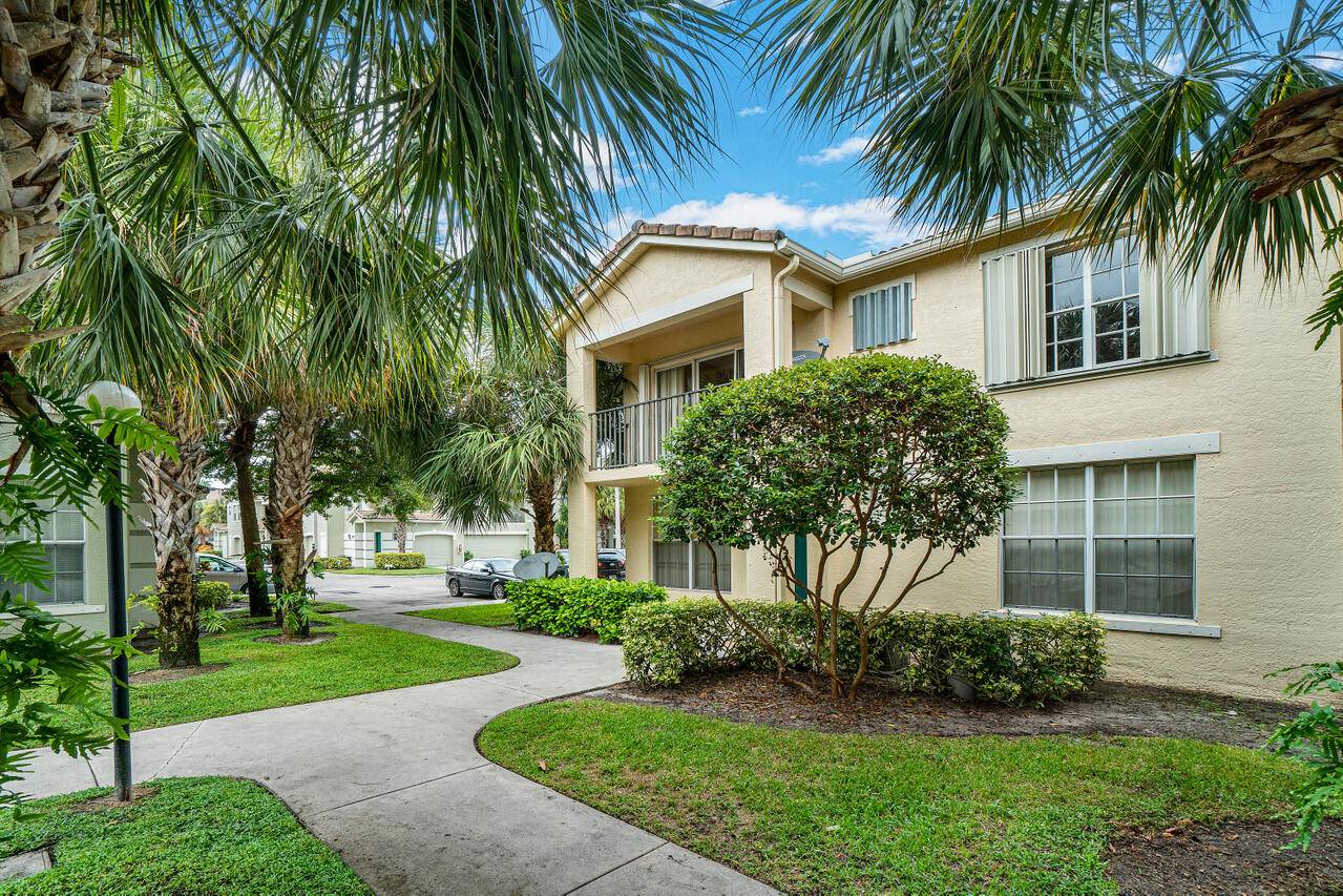 Spacious 2BR 2BA coach home with 1 car garage in gated Residences of Belmont.
