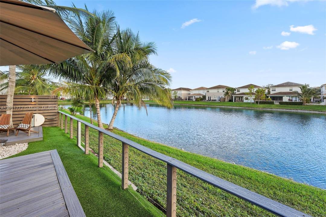 Enjoy gorgeous Miami sunsets lakeside in this beautifully maintained four bedroom home within the gated community of Biarritz in Doral.