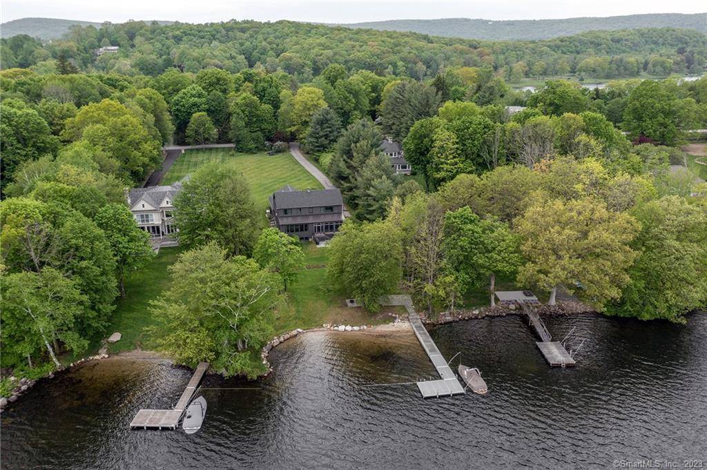 Spend the summer in this recently constructed home steps away from your own private sandy beach and dock.