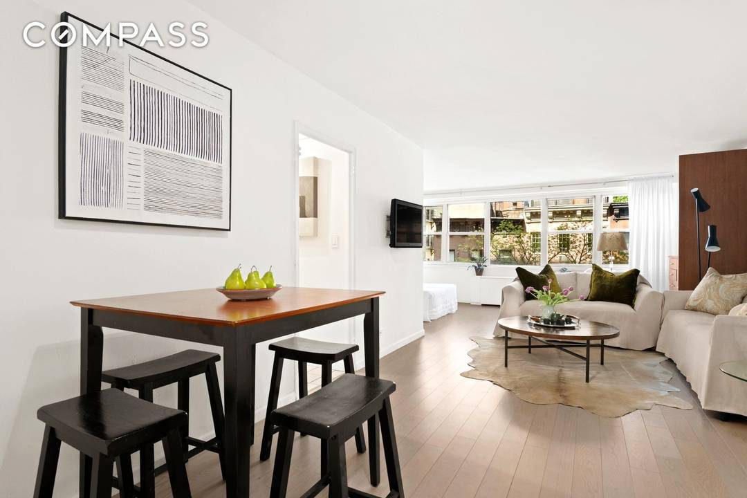 With a wall of five contiguous windows, this oversized alcove studio feels like a one bedroom.