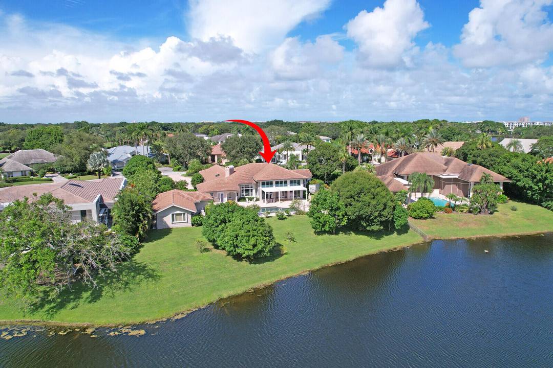 NEARLY ONE ACRE LOT ! Breathtaking lakefront beauty is showcased in this spacious, light filled single story residence in the prestigious community of Frenchman's Creek.