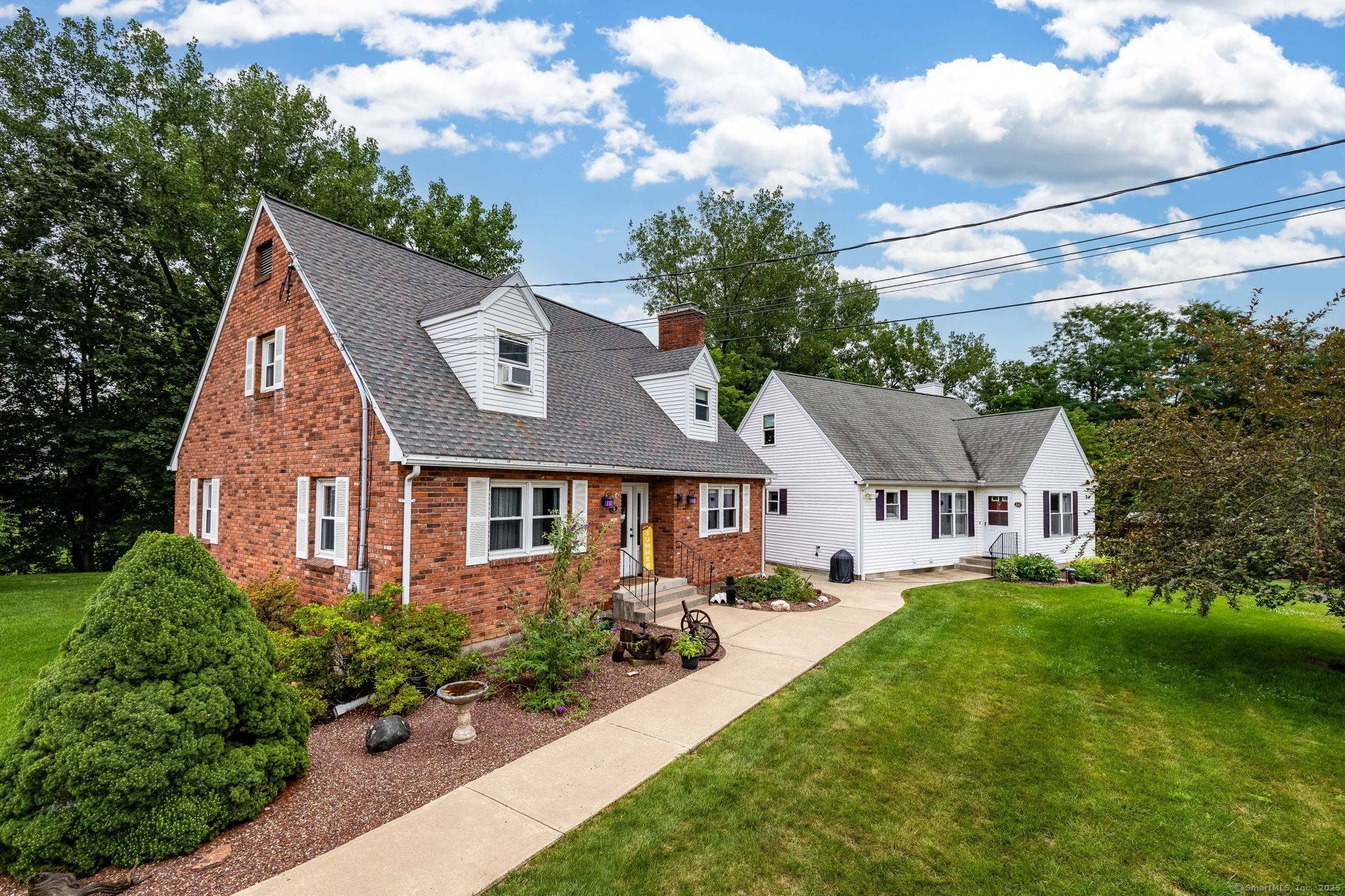 This is a very unique property in that it consists of 2 residential Cape style homes, connected by a terrific heated, finished living area.