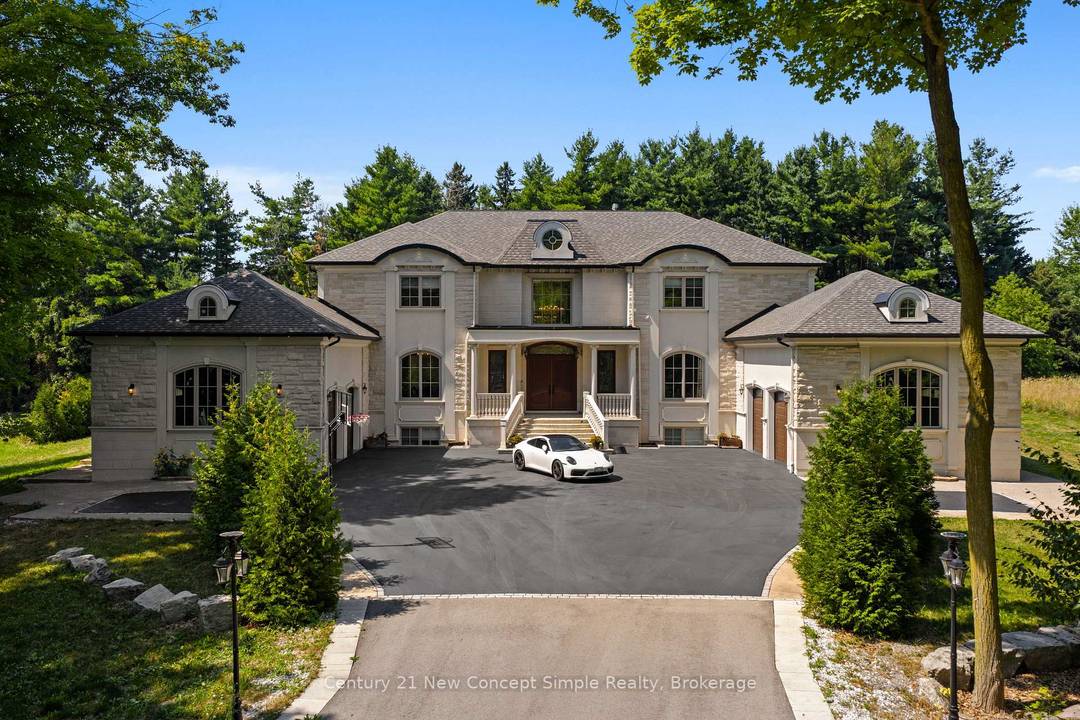 Set on 2. 4 acres atop Burlington's Bluffs, this gated stone clad estate offers more than 11, 000 sq.