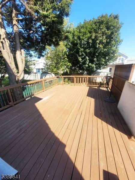 Enjoy an oversized lot located on a residential street in Linden featuring a large deck for entertainment purposes, a two car width gated driveway accommodating 8 vehicles ; a two ...