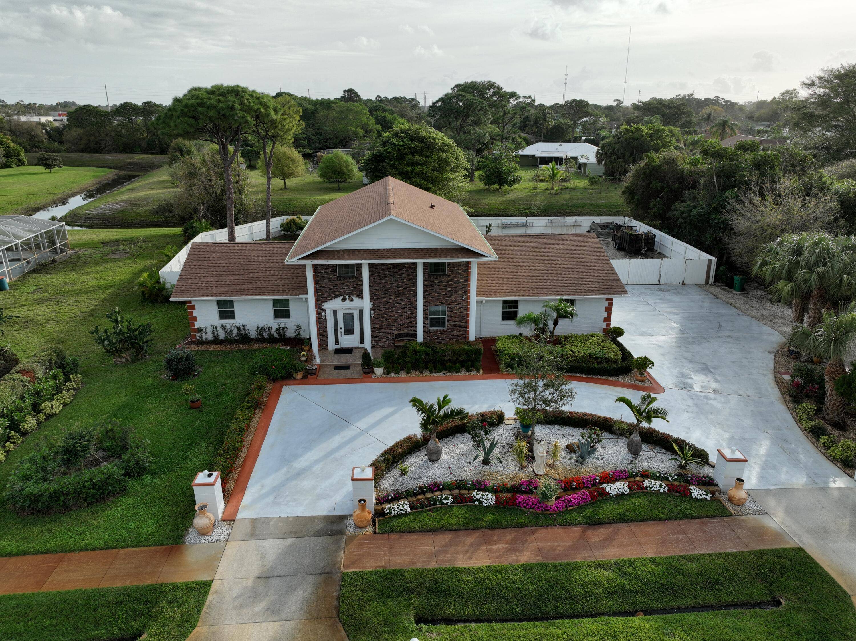 Welcome to a captivating Southern Colonial style estate that blends timeless architecture with modern comfort.