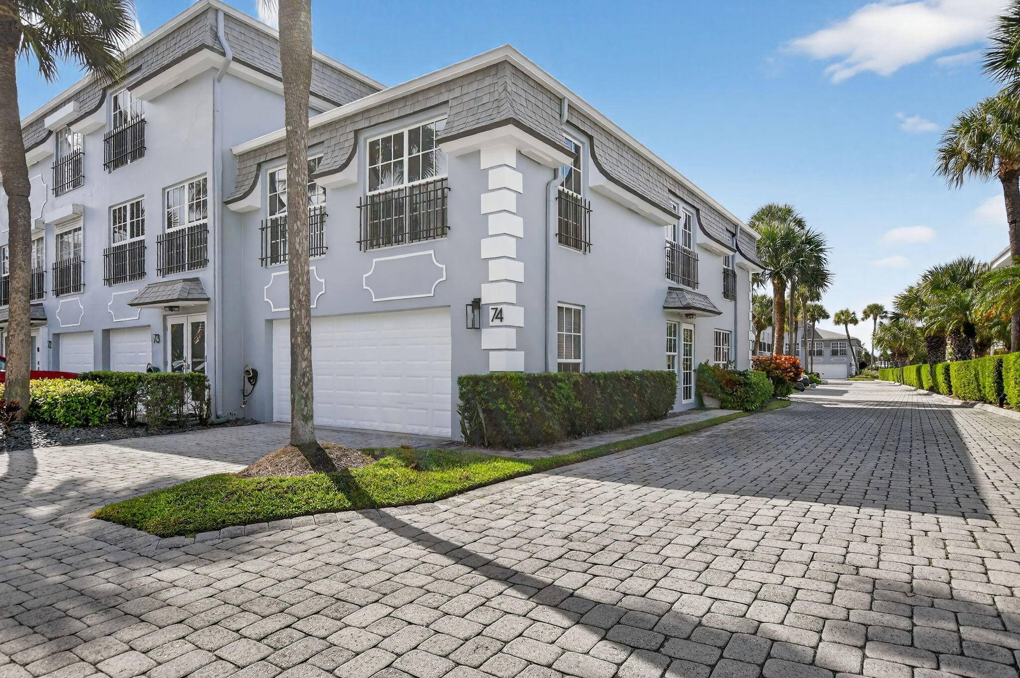 Perfectly positioned between the Atlantic Ocean and the Intracoastal, this townhouse captures the allure of coastal living along prestigious Hillsboro Mile.