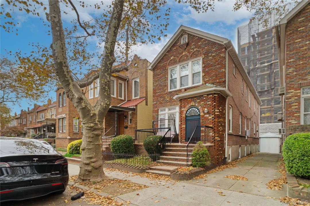 Welcome to a fully detached brick home on a quiet block in Madison Midwood, featuring a private driveway, access to a private alleyway, and a detached brick and stone garage.