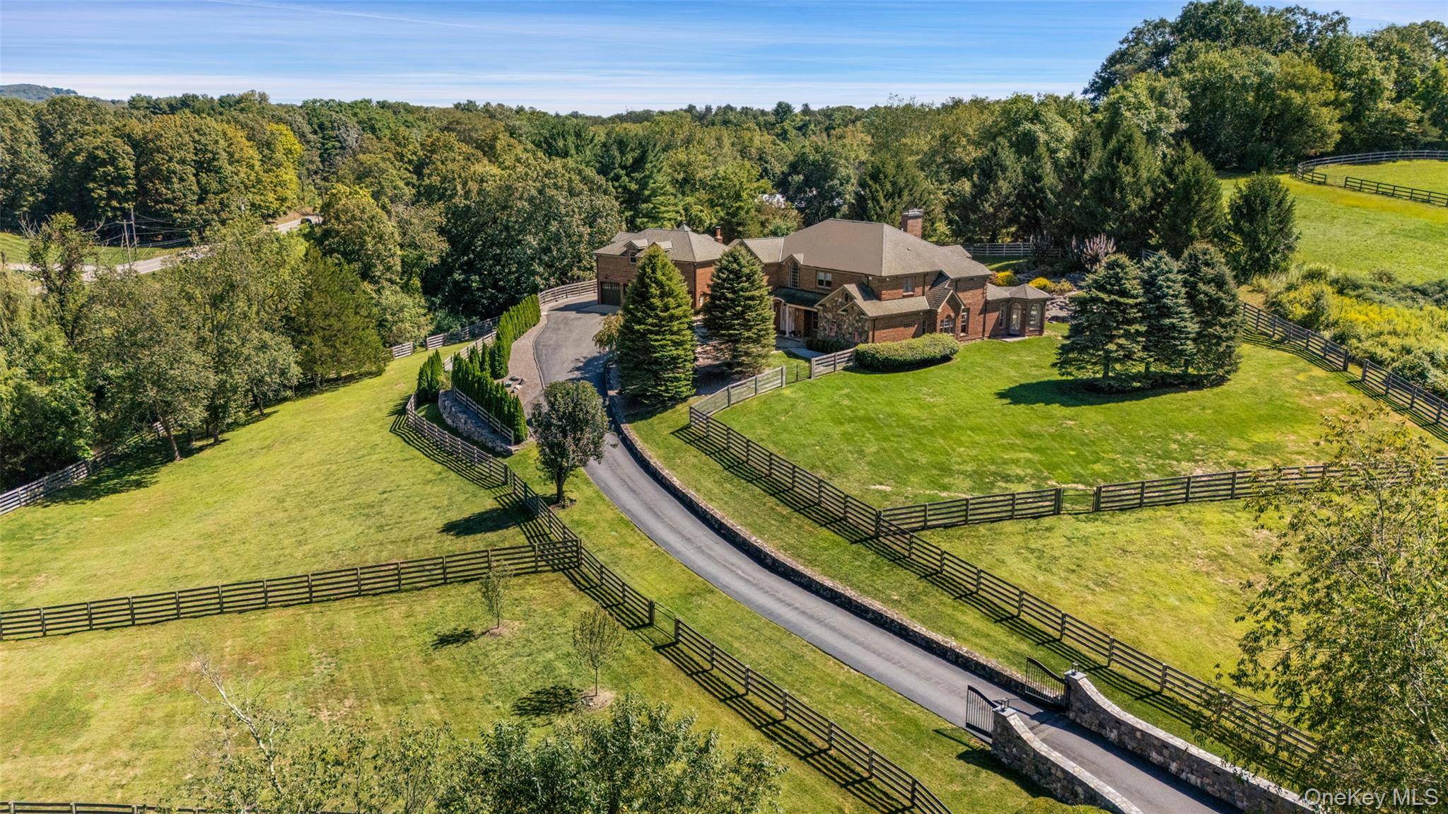 This young, custom built five bedroom brick and stone Bedford country manor sits on pristine property.