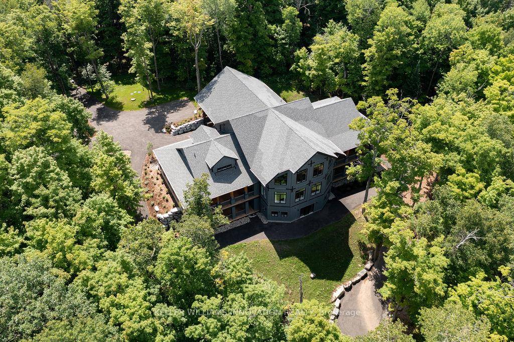 Tucked away on 2. 5 acres of untouched wilderness, this log estate offers a storybook blend of rustic charm and refined comfort.