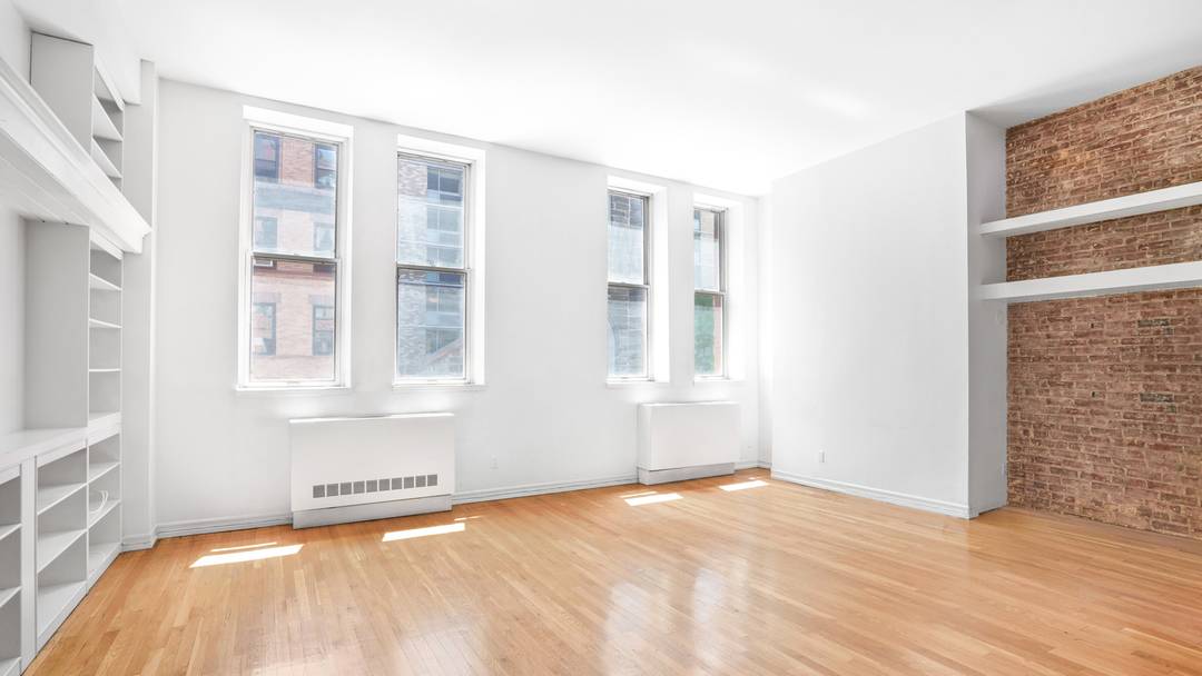 Experience authentic loft living in this rarely available, sun drenched south facing convertible one bedroom loft residence featuring soaring 13'4 foot ceilings, exposed brick walls, oversized industrial style windows, and ...