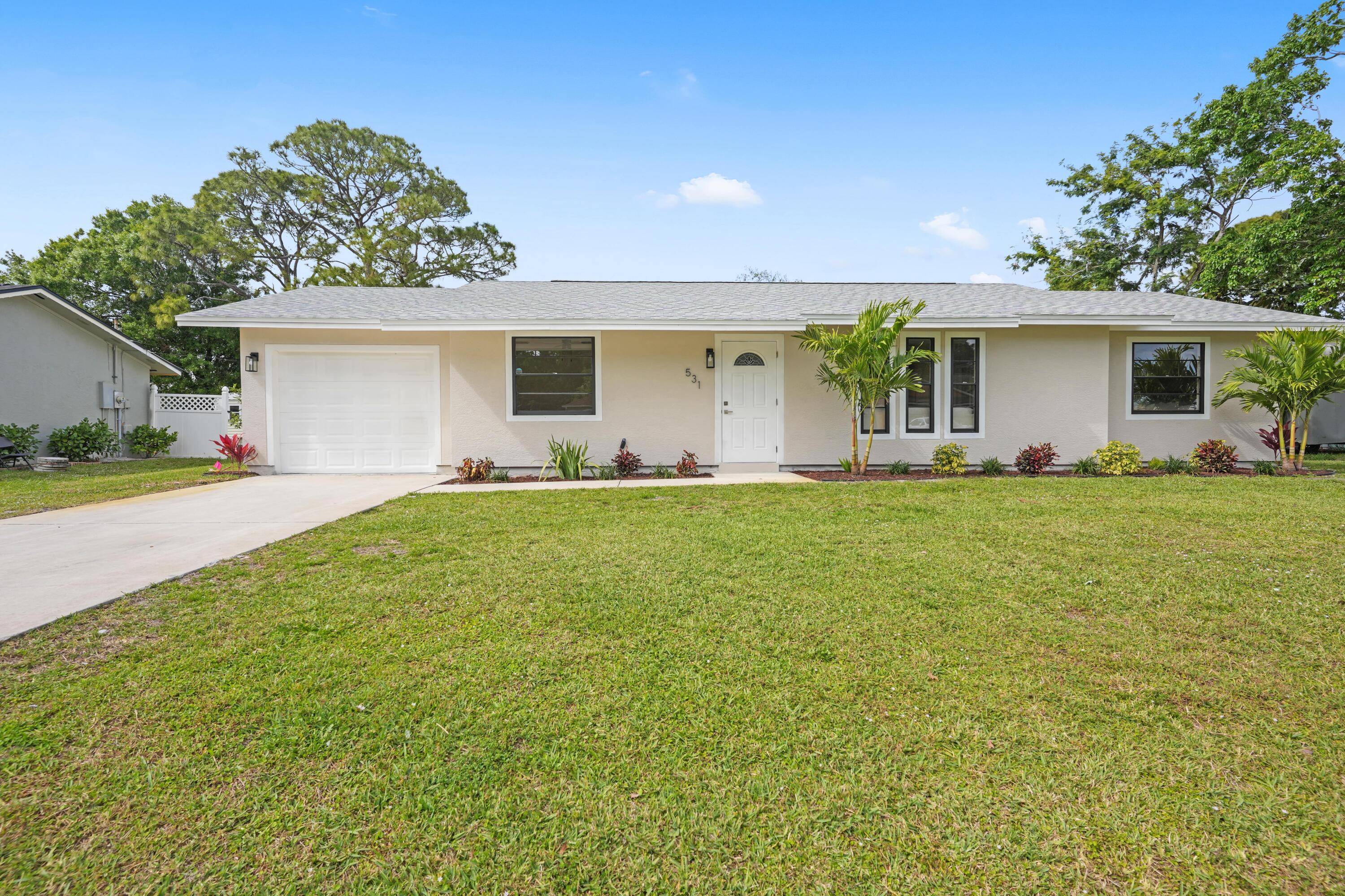 Welcome to this beautifully updated four bedroom, two bathroom home, perfectly situated in the heart of Port Saint Lucie.