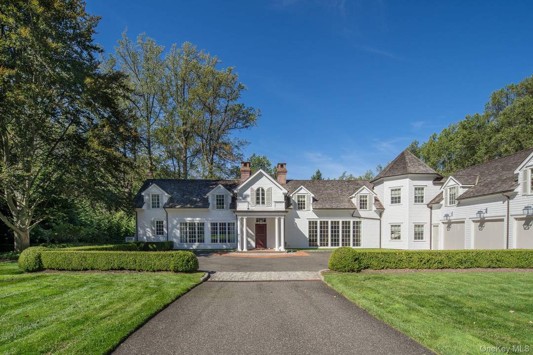 Beyond the private gates sits an extraordinary Carriage House set on 2 acres with pristine gardens, pool, and sport court.