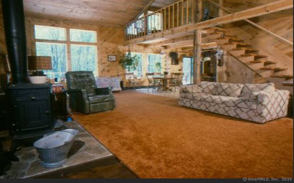 The charming 3 bedroom colonial with a large attached garage and 2 outbuildings overlooks a lovely 5 acre pond.