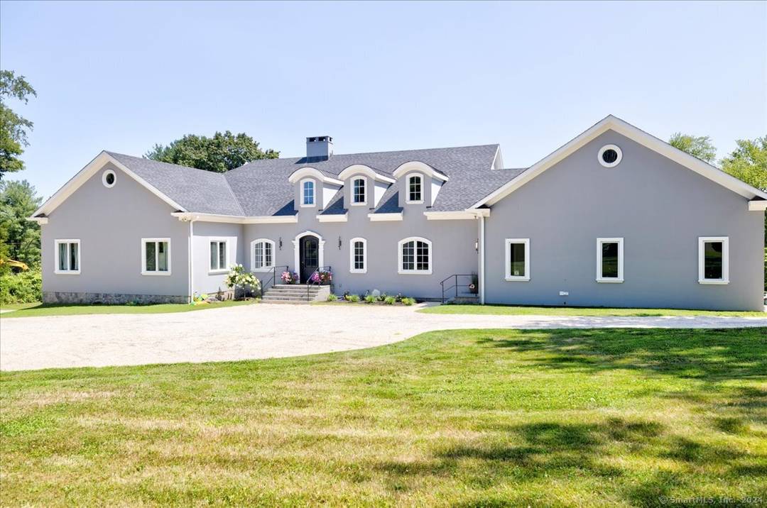 Newer construction featuring elegant French provincial design on over 2 lovely open acres of rolling land bordering an estate area of Greenwich and enjoying a Greenwich address.
